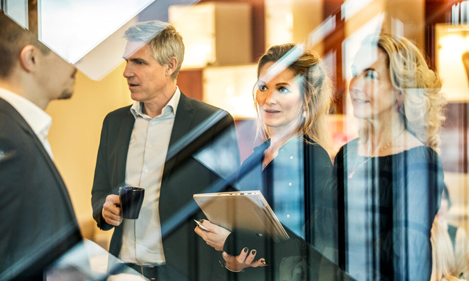 Bild på fyra människor i en arbetsmiljö